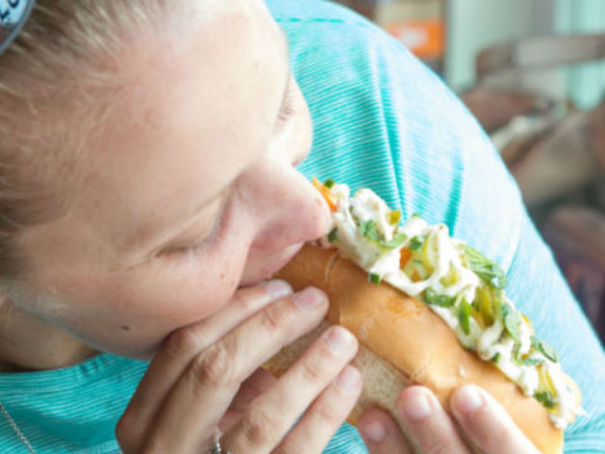 a person eating a lobster roll