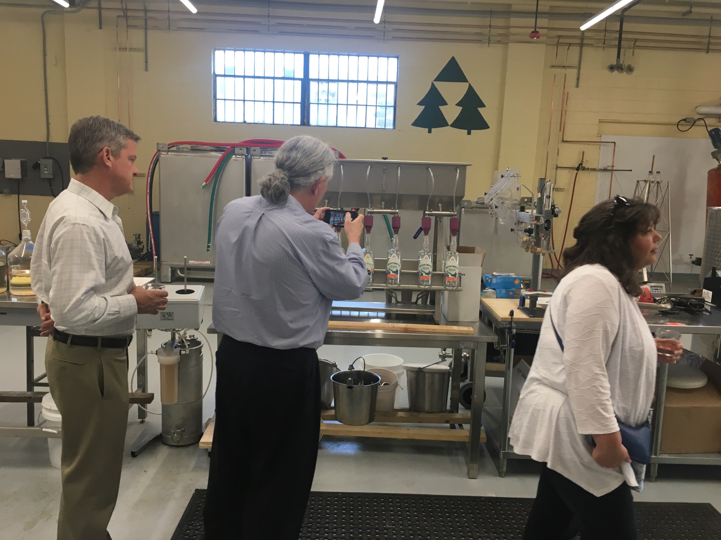 a group of people on a distillery tour