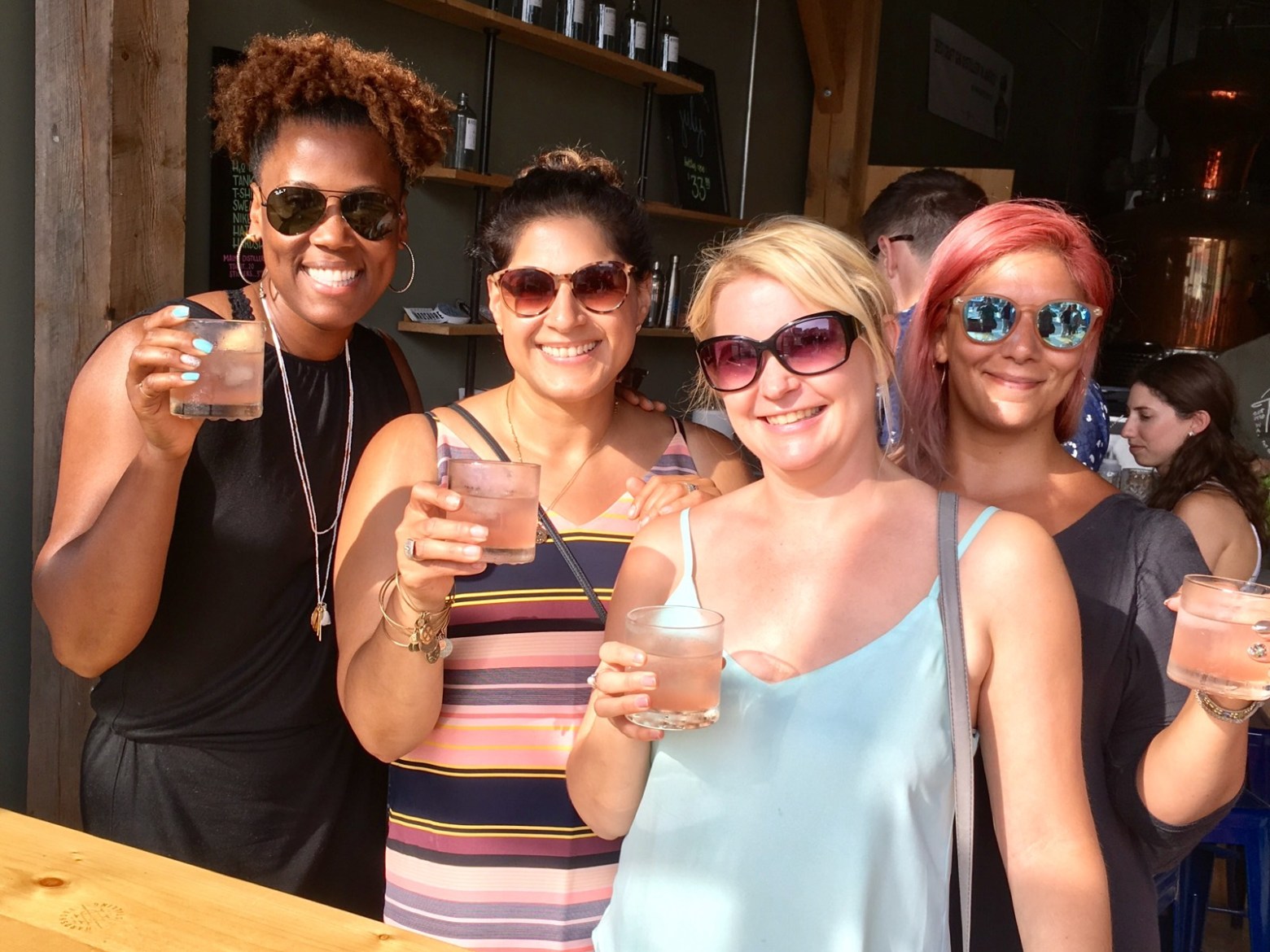 a group of ladies posing with drinks for the camera