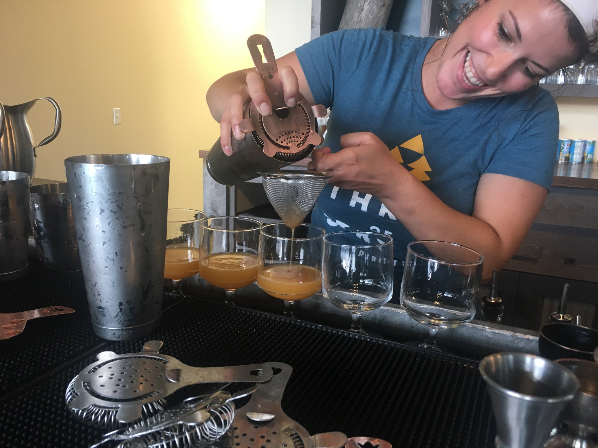 a woman preparing a cocktail