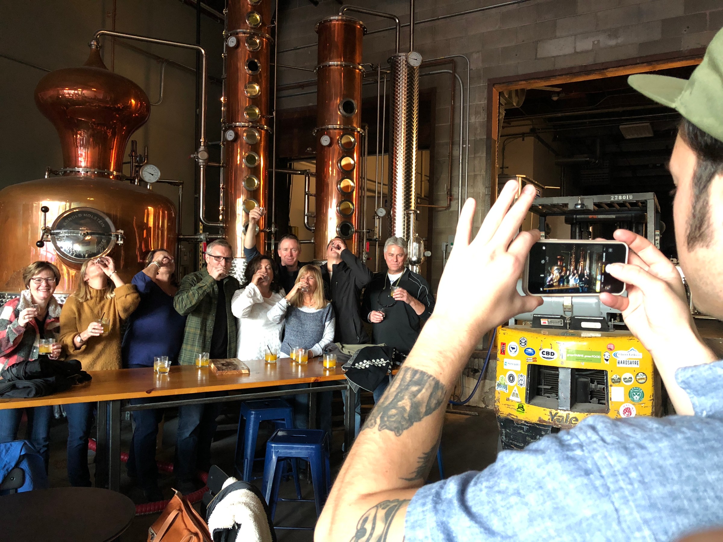 tour group posing for a photo while drinking gin