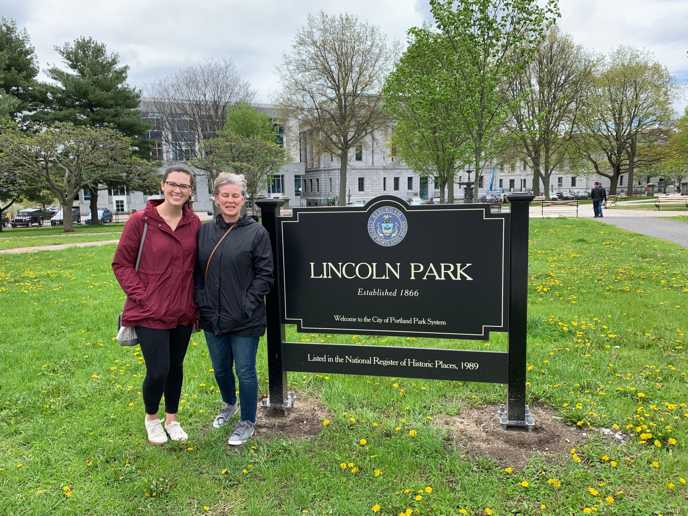 couple standing at a sign posing for a photo