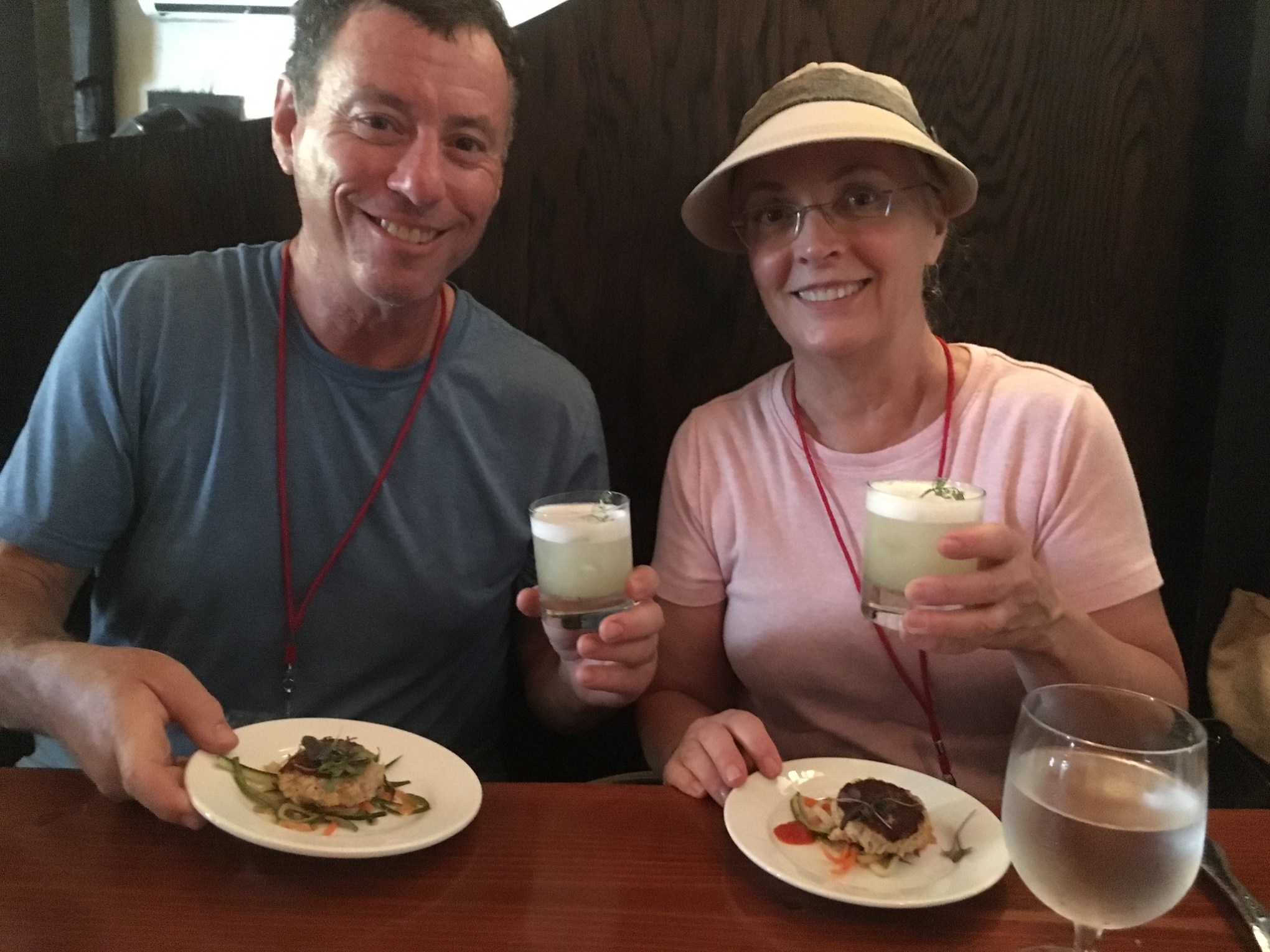 a man and a woman sitting at a table with a plate of food