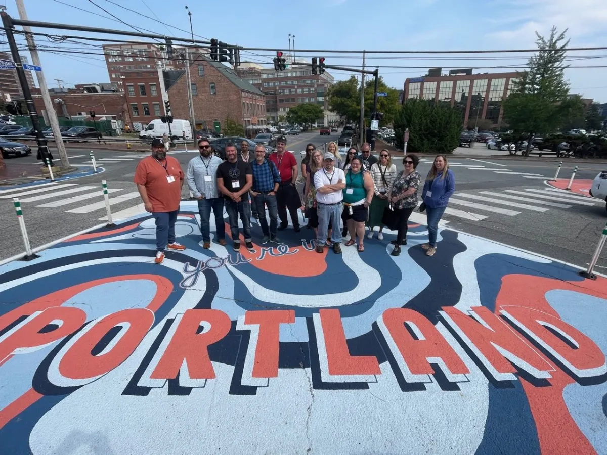 a group of people painted on the side of a road