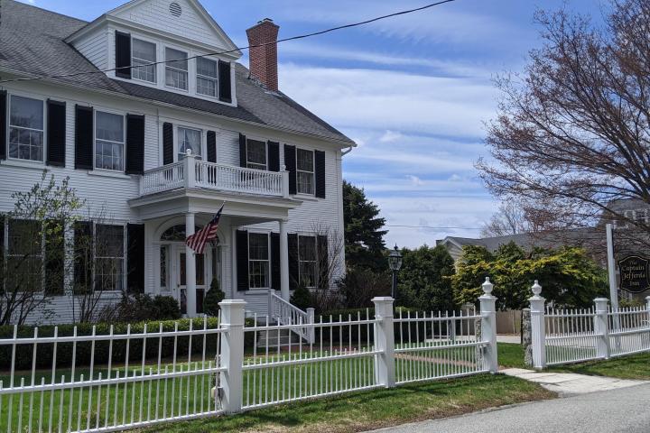 a house with a fence in front of a building