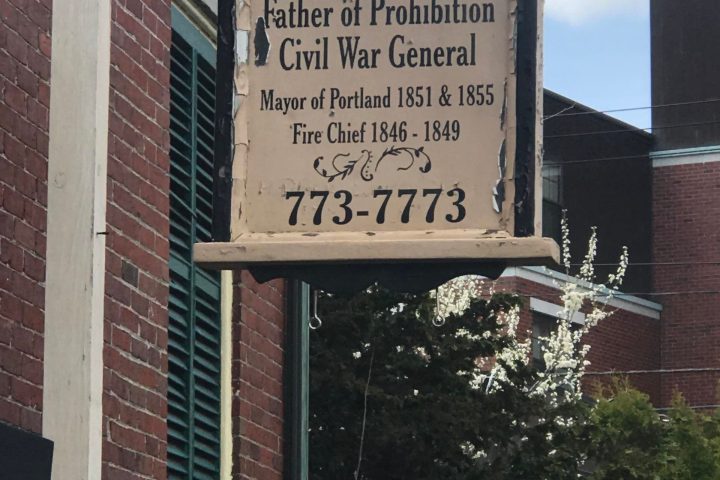 a sign in front of a brick building