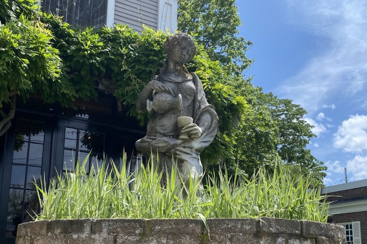 a large stone statue in front of a building