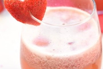 a close up of a glass of orange juice