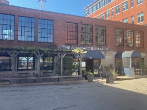 a large brick building with a store on the side of a road