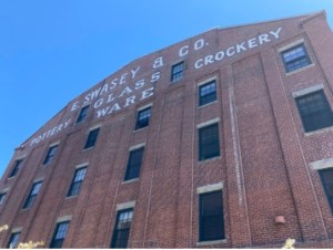 a large tall tower with a clock on the side of a building
