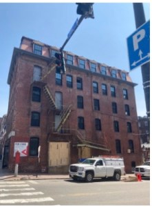 a building that has a sign on the side of the street