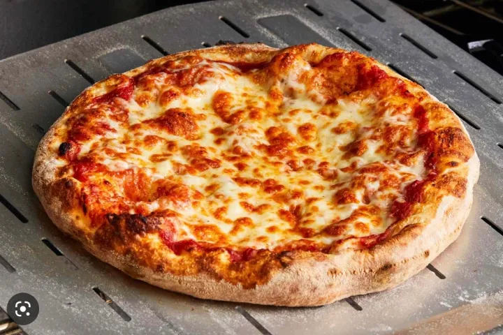 a pizza sitting on top of a metal pan