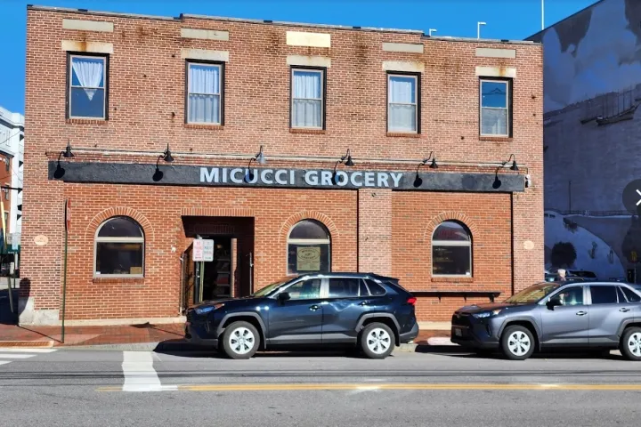 a car parked on a city street in front of a brick building