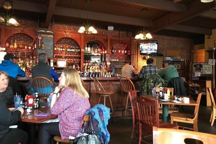 a group of people sitting at a table in a restaurant