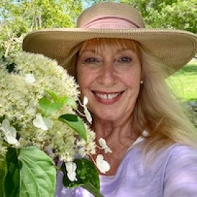 a woman wearing a purple flower