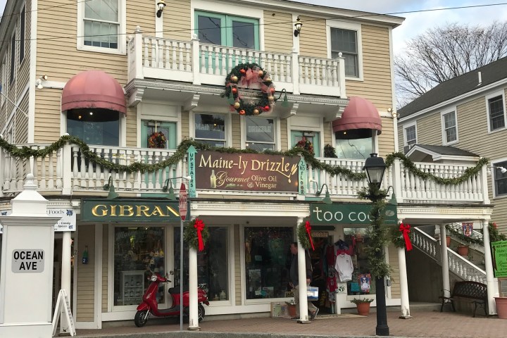 a group of people walking down a street in front of a store