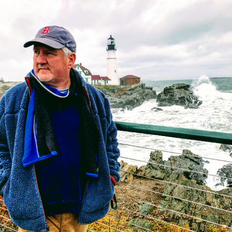 a man standing next to a body of water