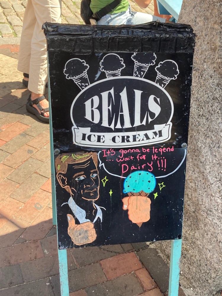 a sign on a brick sidewalk