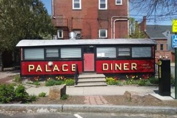a building that has a sign on the side of a road