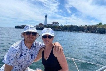 a man and a woman sitting on a boat in a body of water