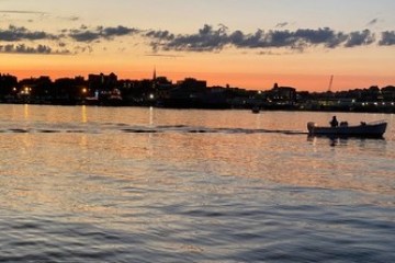 a train crossing a bridge over a body of water
