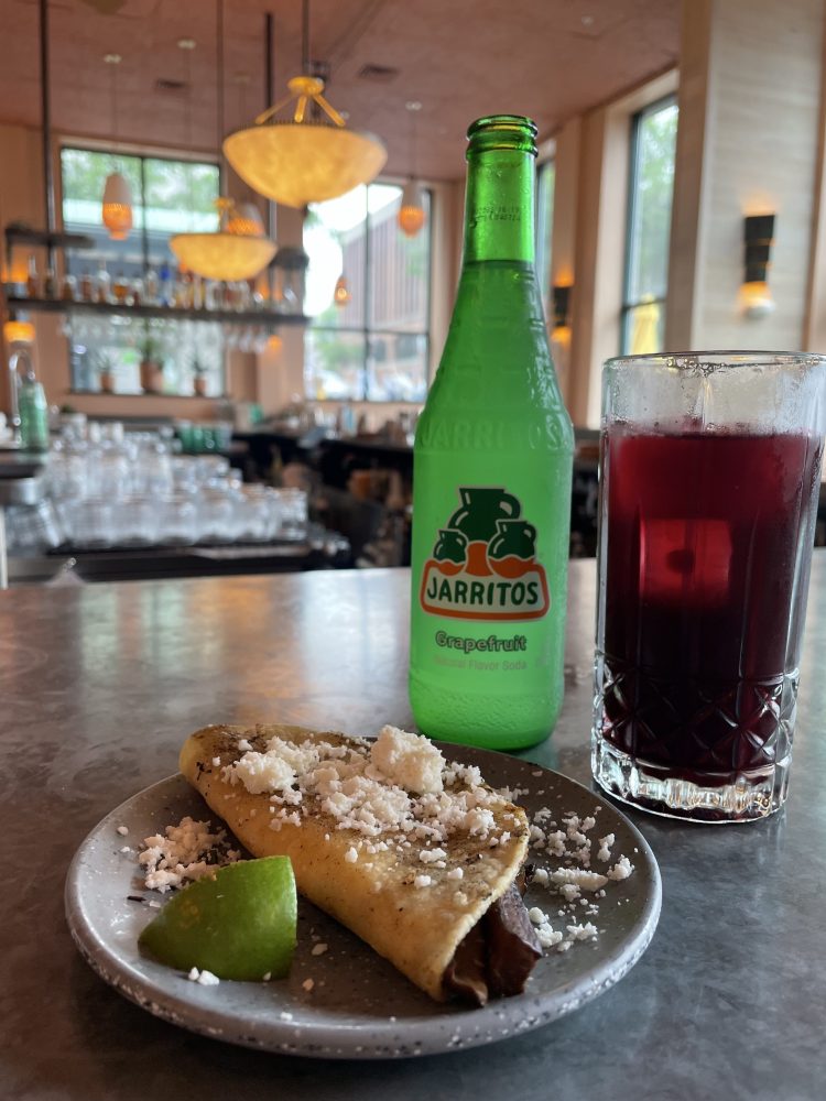 a plate of food and a glass of beer on a table
